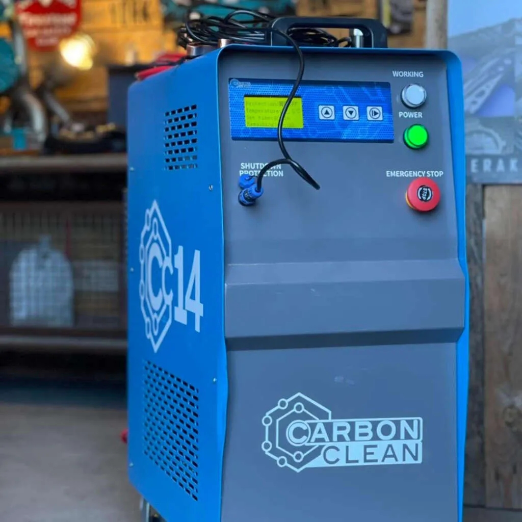 Engine Carbon Cleaning – Stoke-on-Trent Hydrogen engine carbon-cleaning device with red hose attached to a car’s intake in a Stoke-on-Trent workshop.