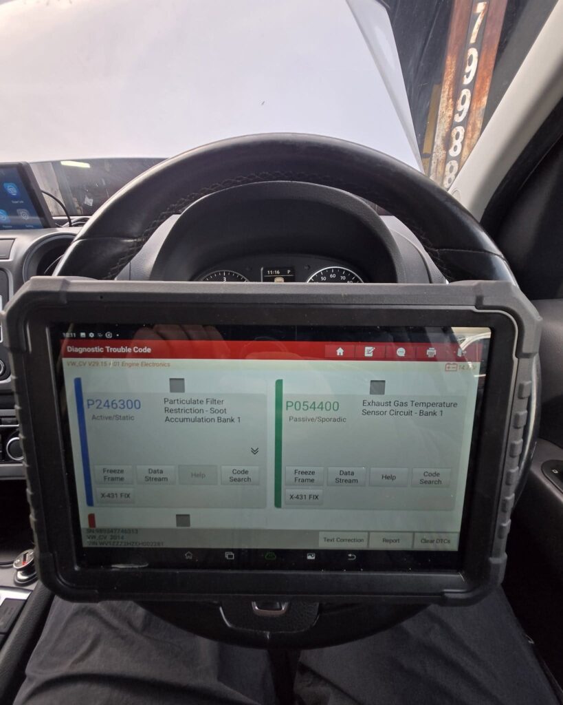 Diagnostic tablet showing DPF fault codes before cleaning