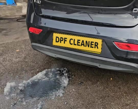 Soot and residue flushed out of a DPF during a clean